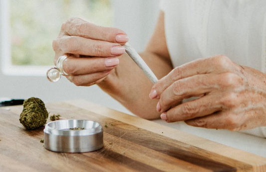 Senior holding a rolled marijuana