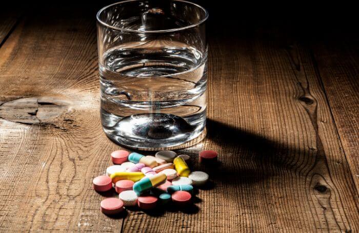 Glass of water and prescription drugs