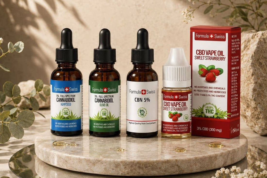 Formula Swiss 5% CBD oils in hemp seed oil and olive oil, CBN oil 5% and a strawberry CBD vape oil on a marble stand