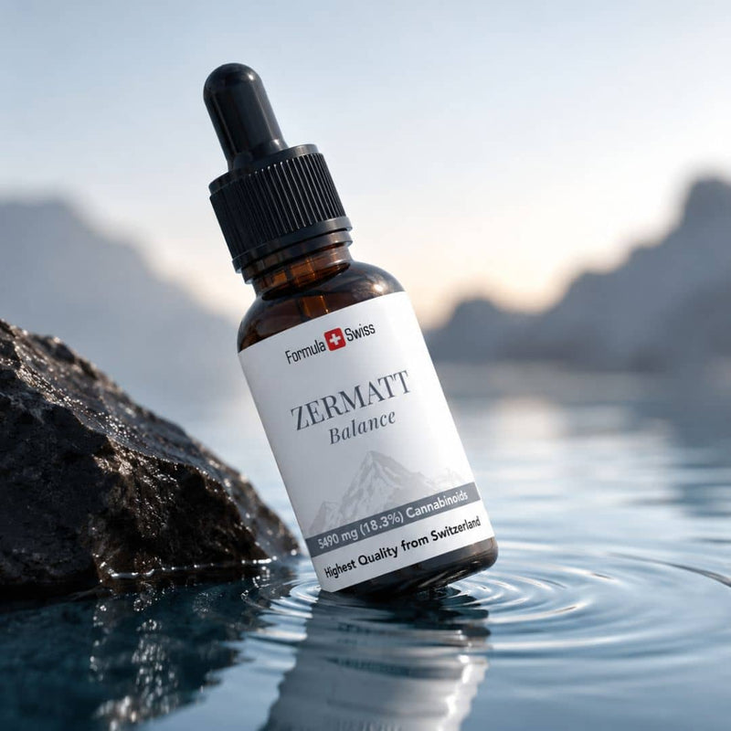 Formula Swiss Zermatt Balance cannabinoid oil bottle displayed beside a rock in clear water with a Swiss mountain backdrop.